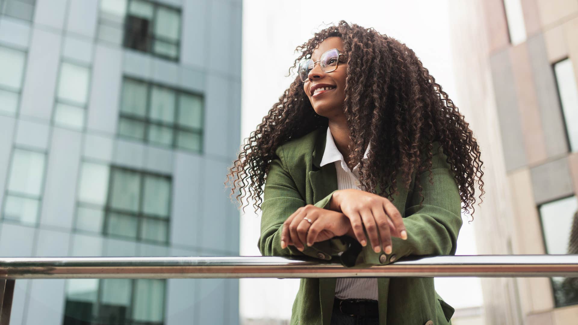 Woman who has a strong sense of purpose smiling outside.