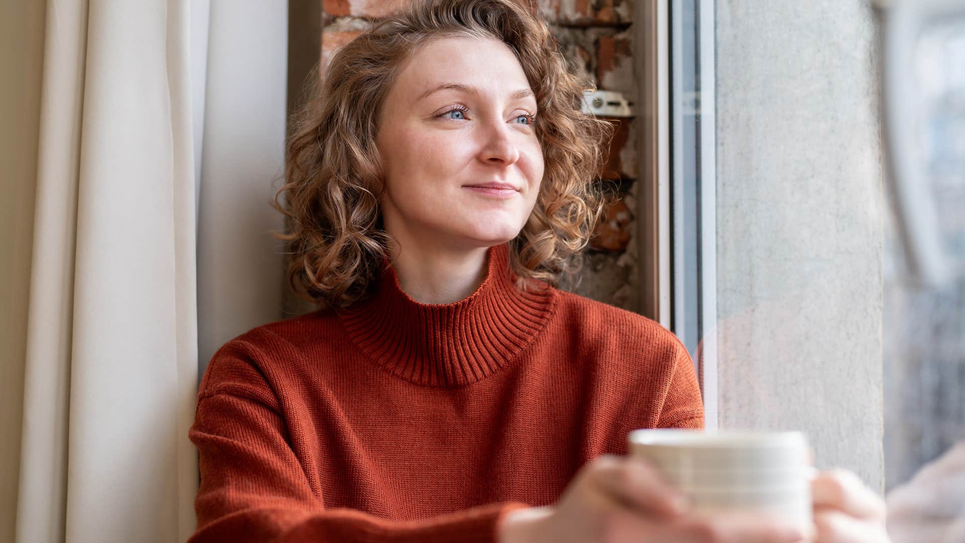 high-value woman drinking tea curating her bedtime and morning routines