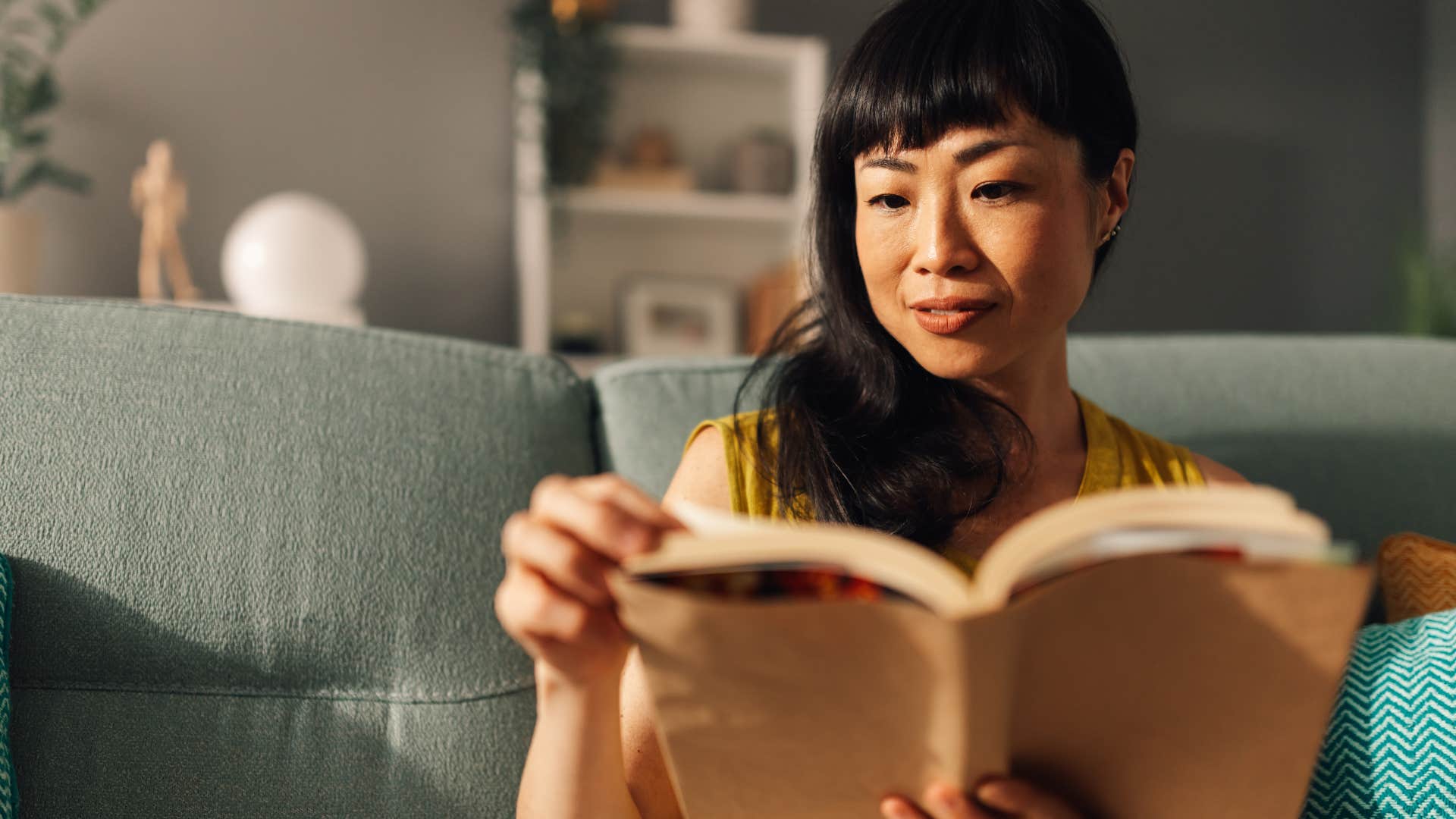 high-value woman disconnecting from her phone and reading a book