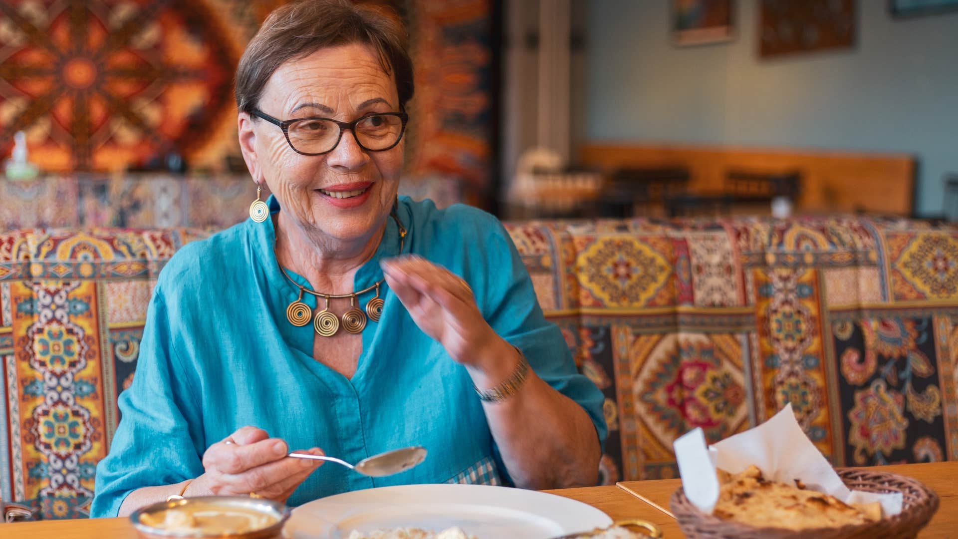 happy high-value woman going out alone eating at a restaurant