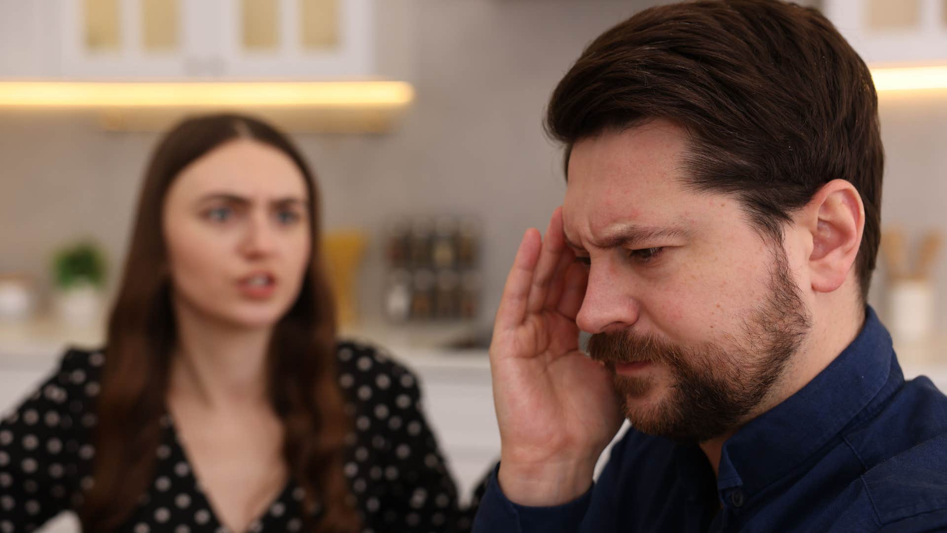woman yelling at unhappy husband who walks on eggshells around her