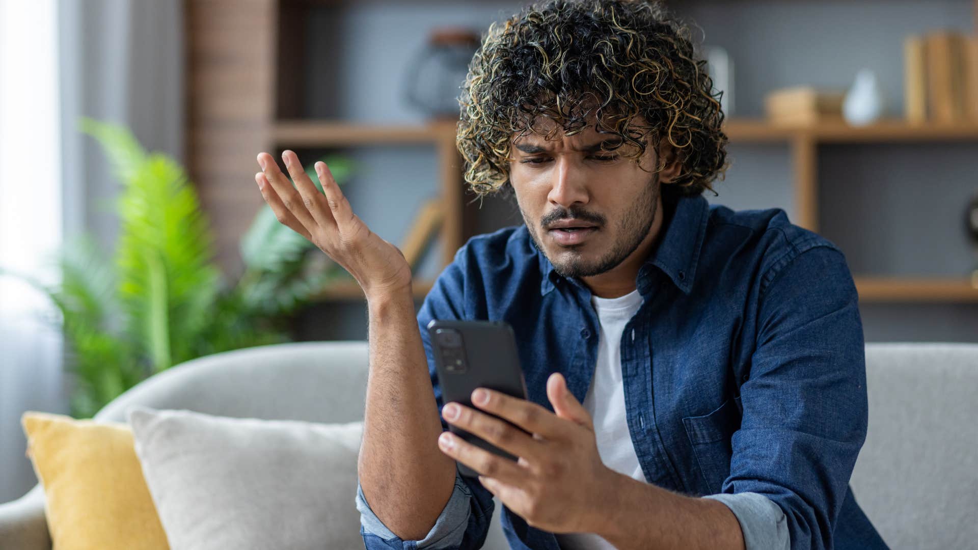 frustrated man looking at his phone