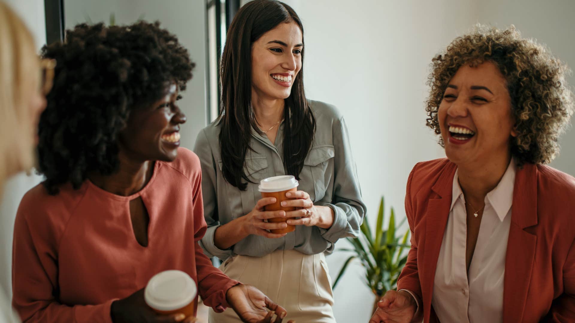 friends laughing in the kitchen with one woman telling them I feel like I've known you forever