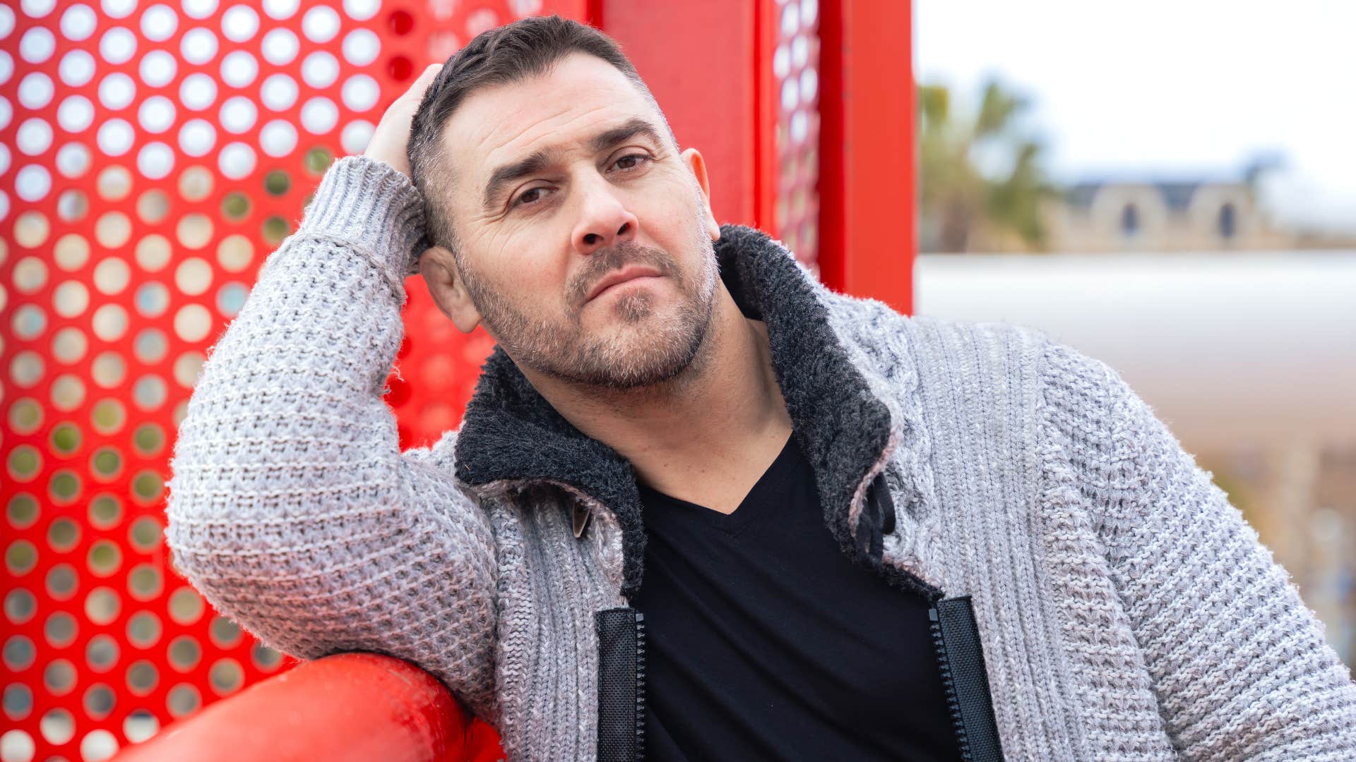 man who feels uncomfortable when people stand too close in line people-watching outside