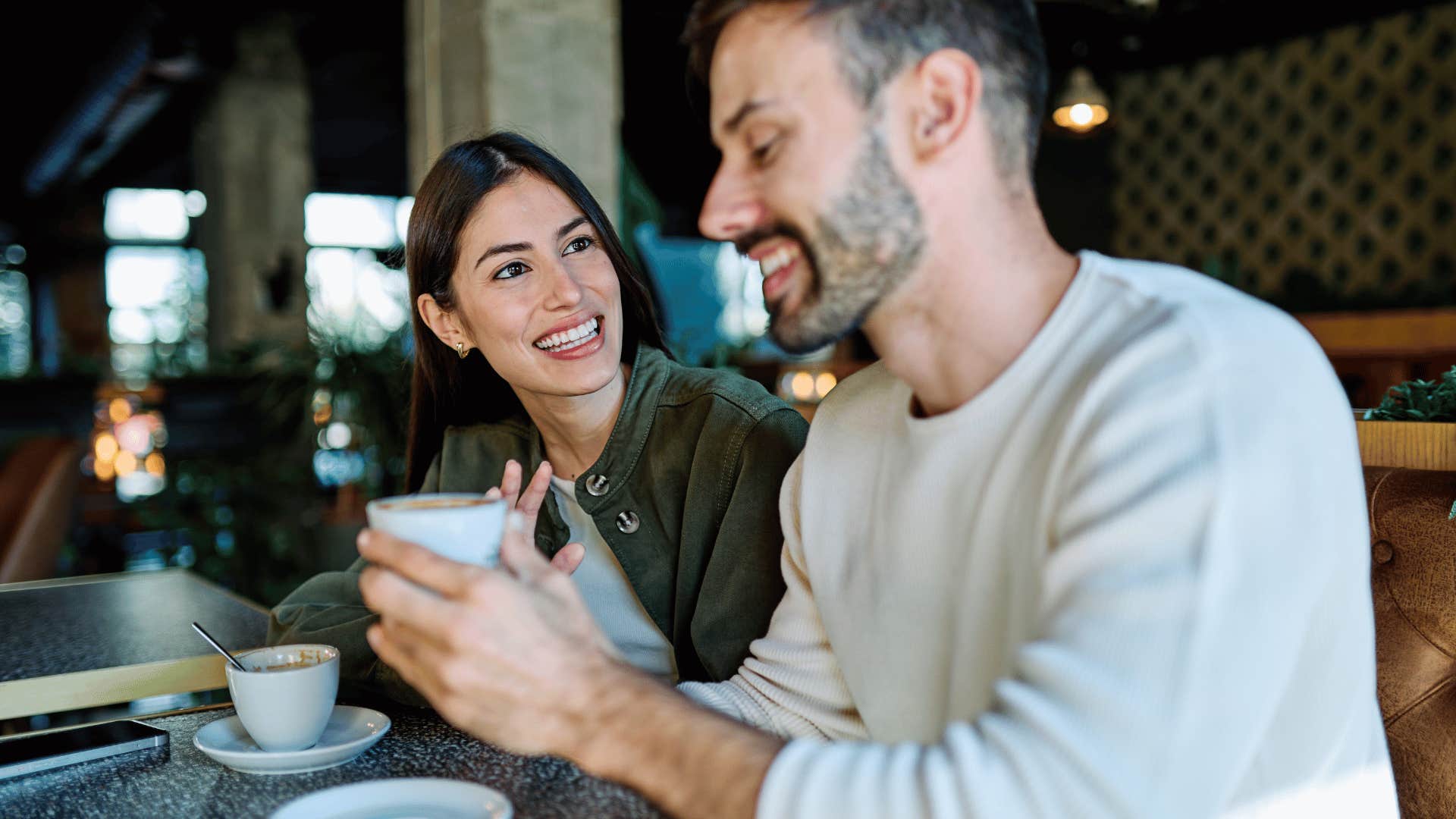 man who is more serious than woman realizes as he asks thoughtful questions