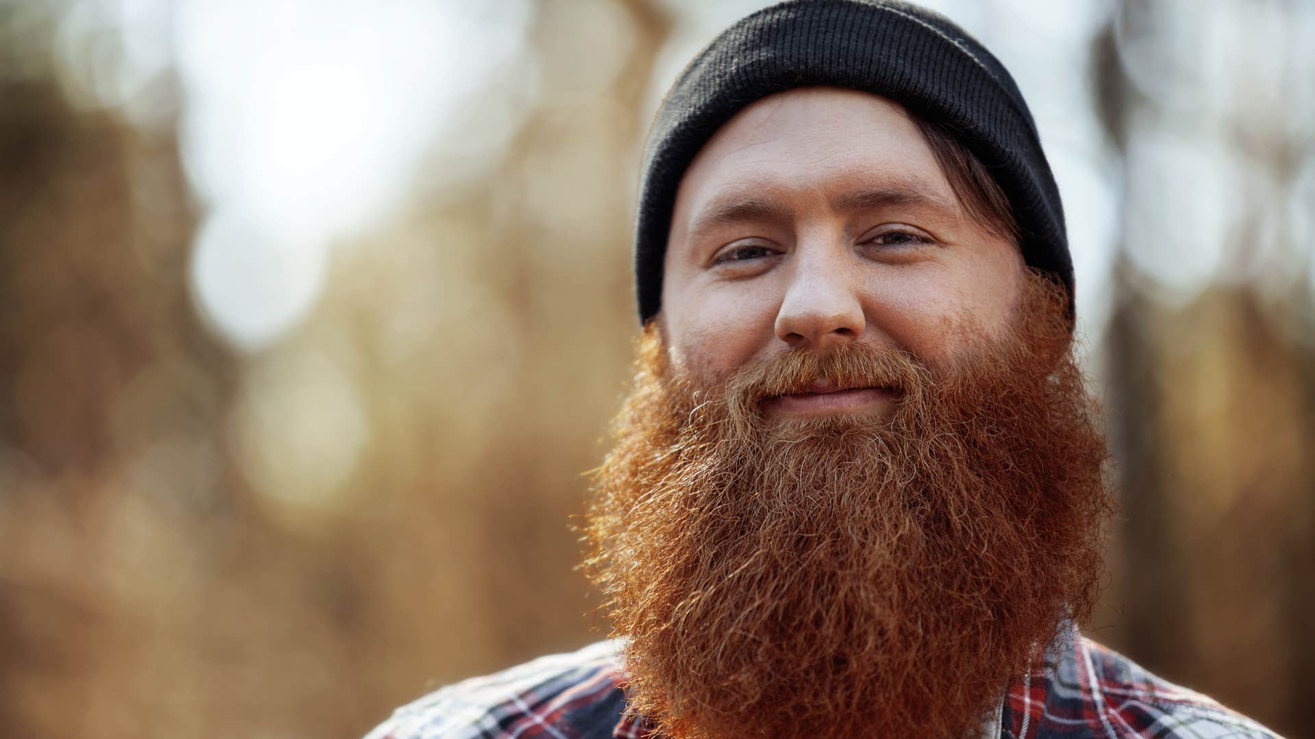 independent man smiling preferring to be alone than being fake friends with someone