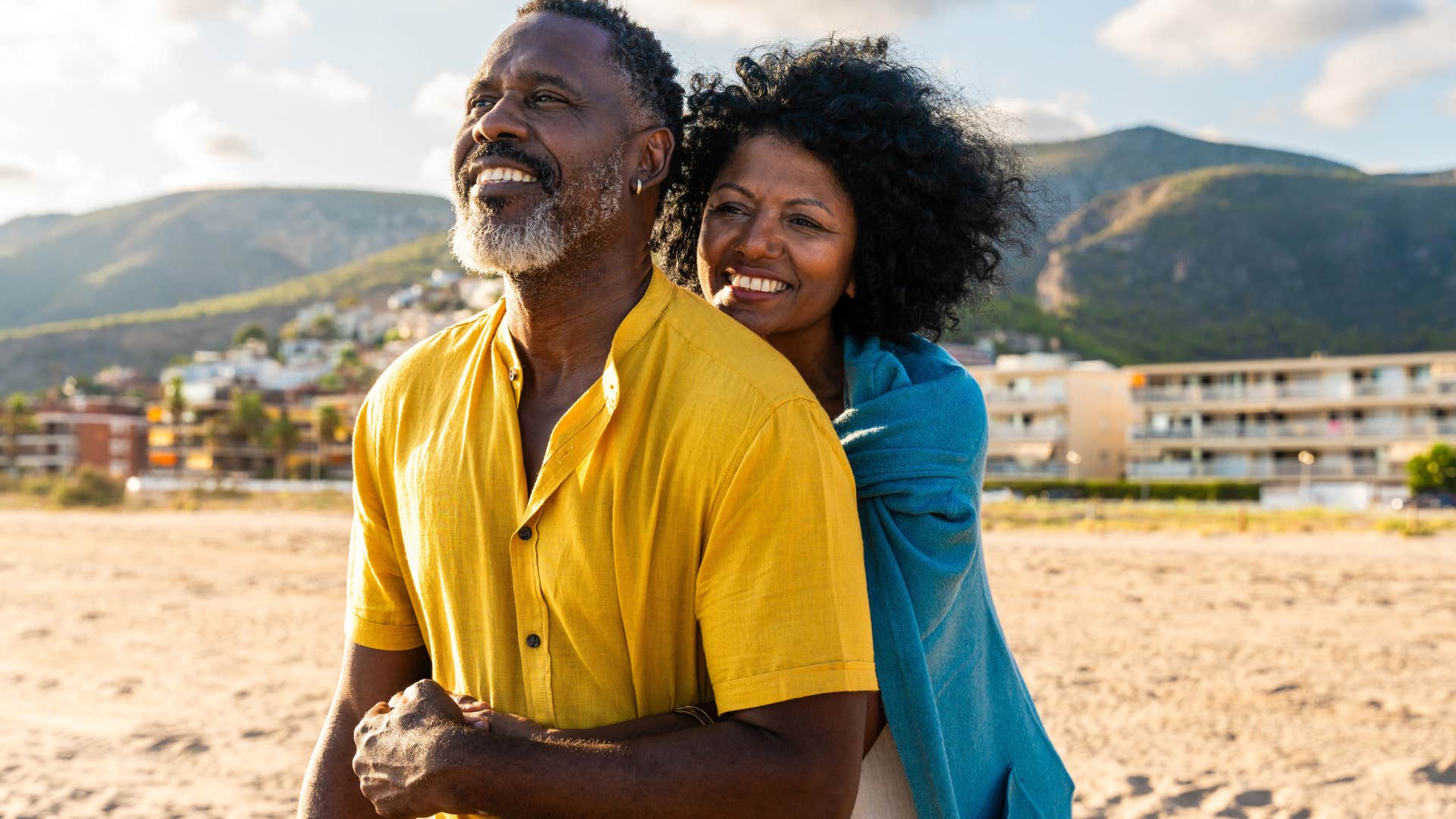 couple who committed without knowing everything smiling on the beach