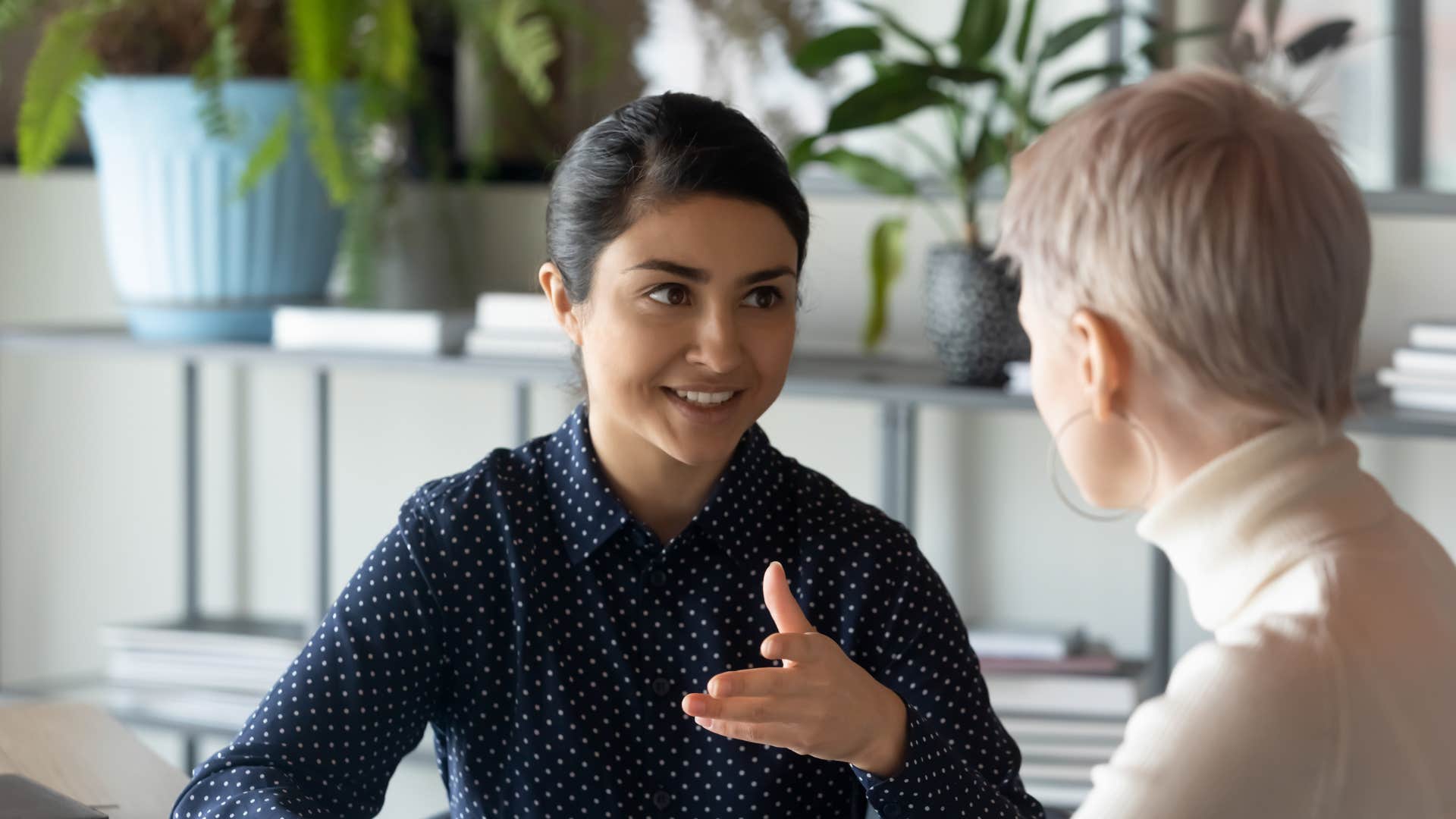 Focused leader explains details to staff showing conscientious trait