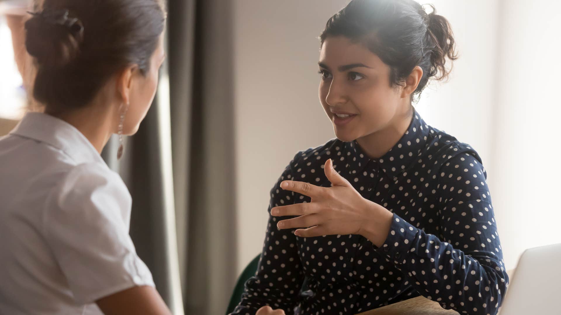 woman telling colleague I'm not an expert but...