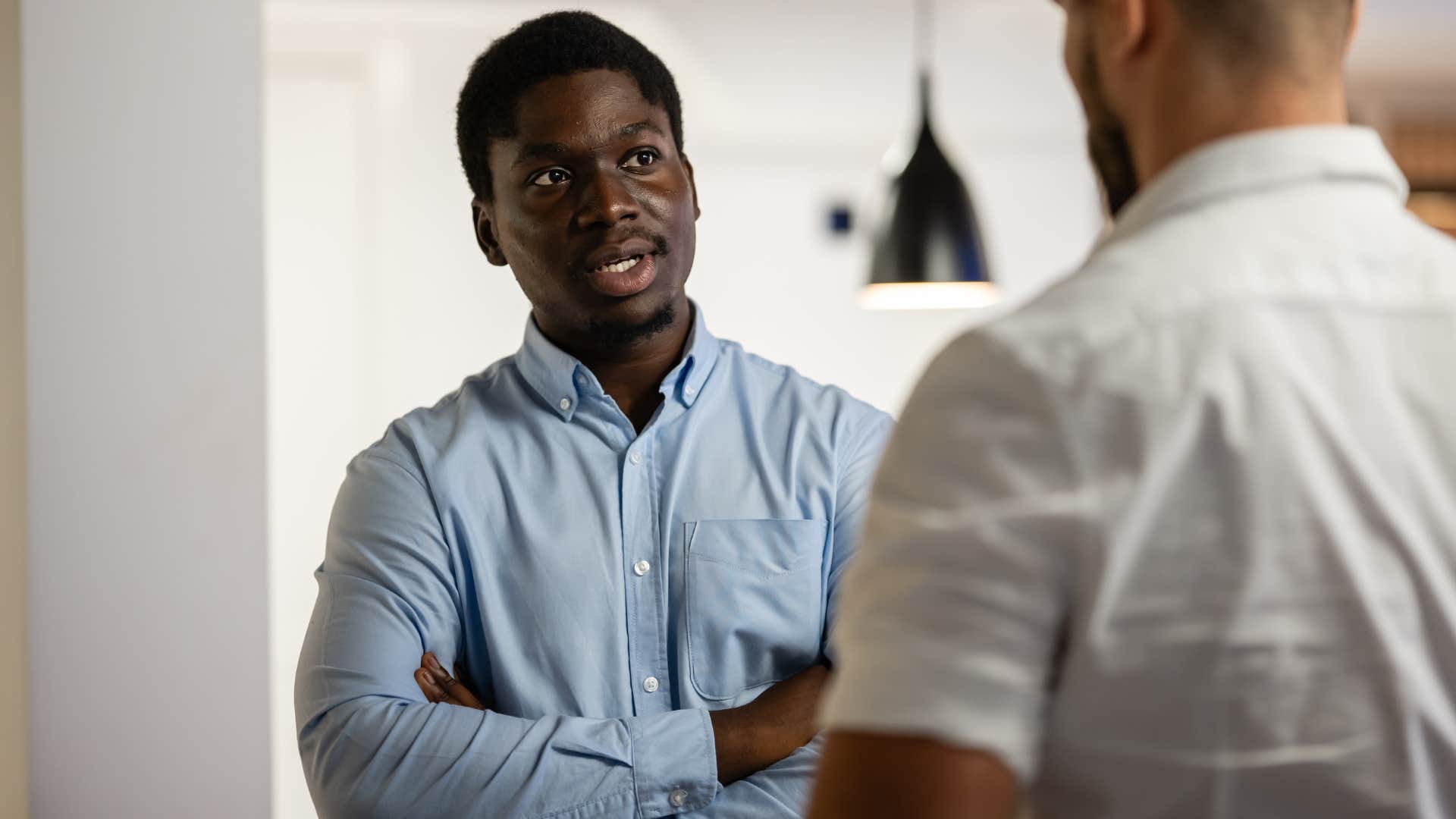 man seeming uneducated telling friend it is what it is