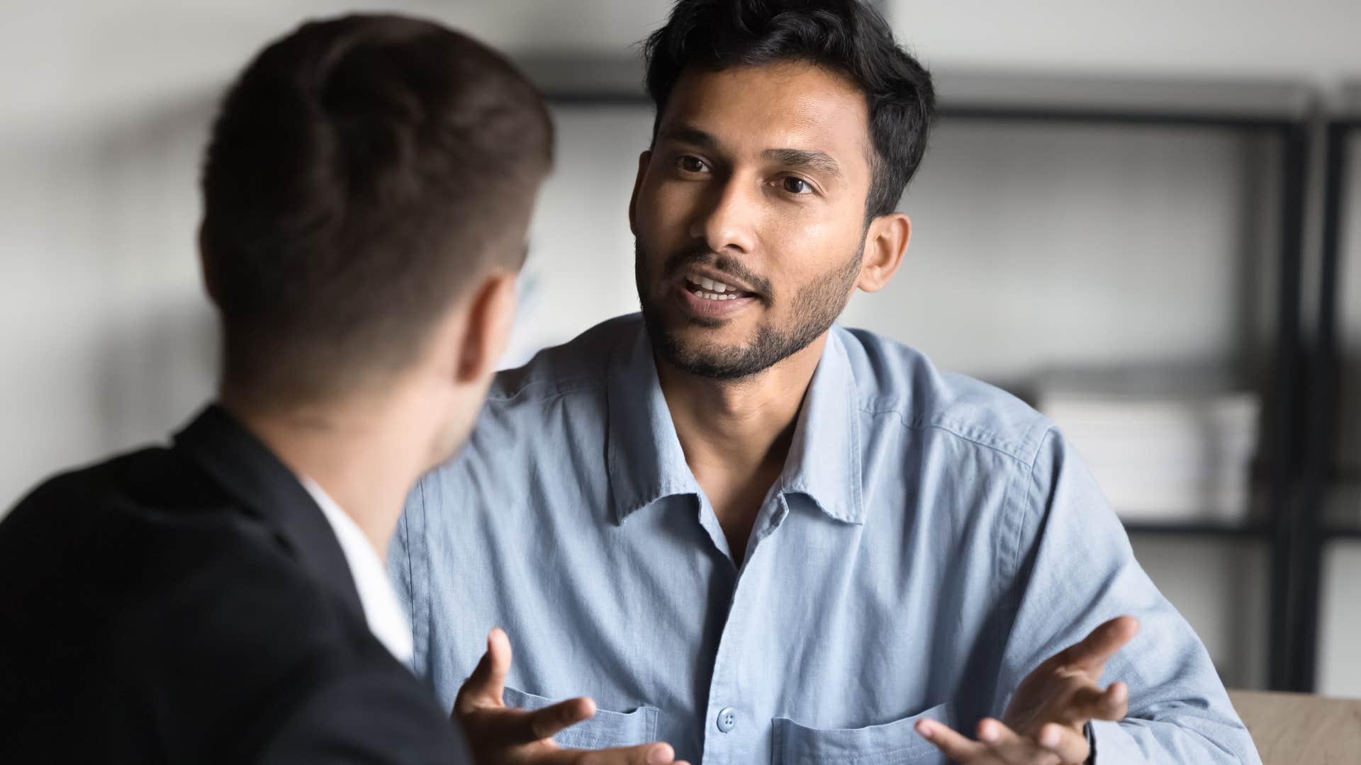 man seeming uneducated telling coworker it's like...