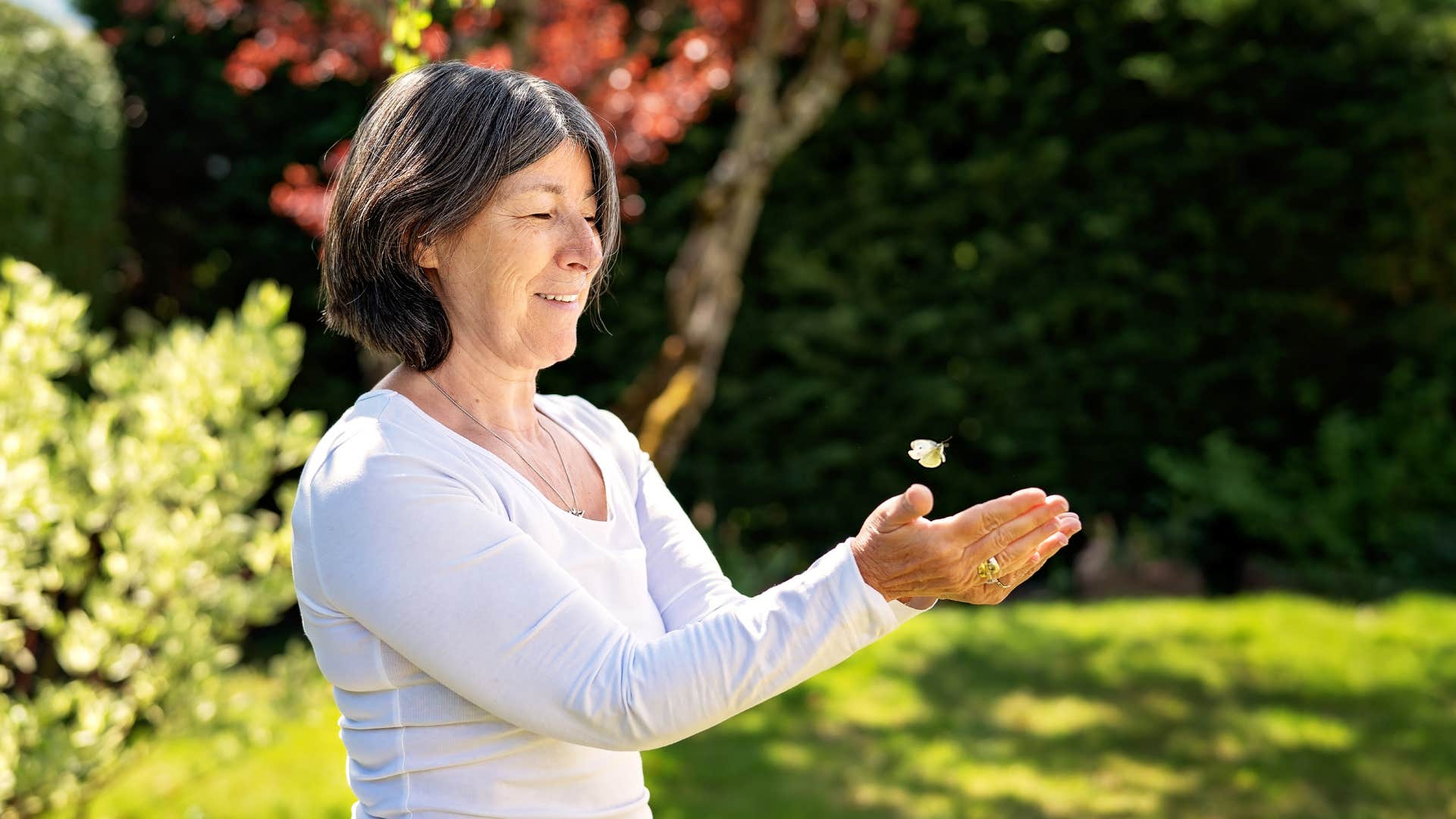 Happy person catches butterfly in hands showing habit of visualization