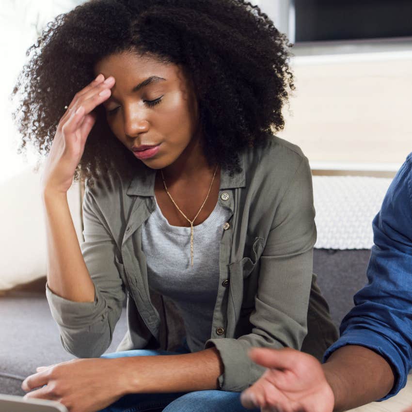 anxious woman sitting with a partner who distorts her reality