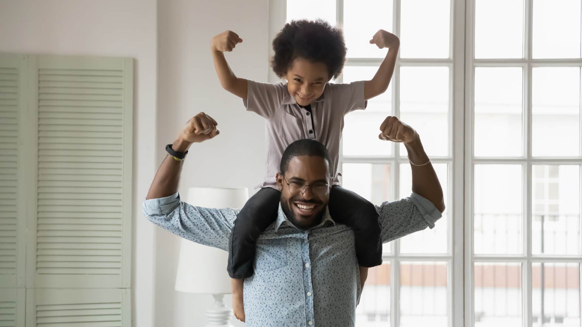 Fearless boy sits on father's shoulders