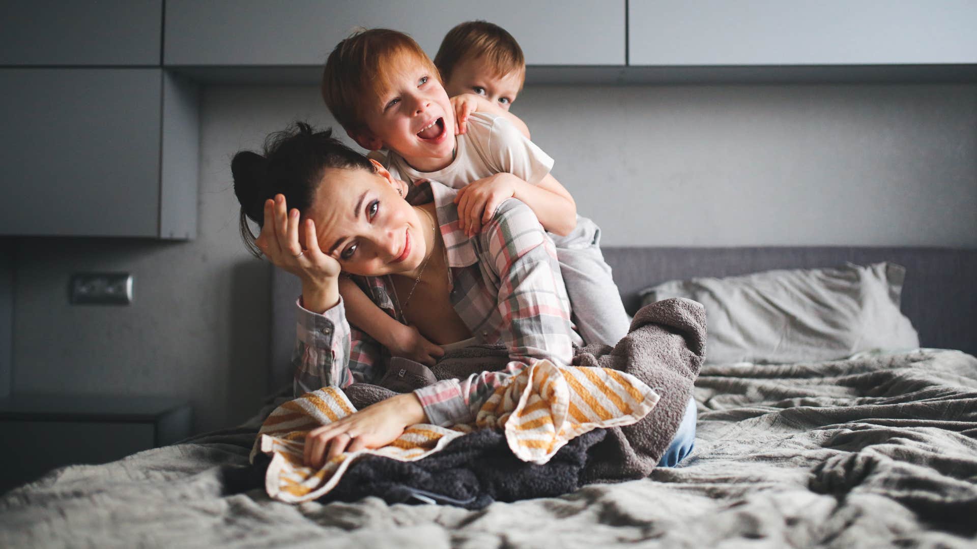 mom unable to find privacy with her kids jumping on her