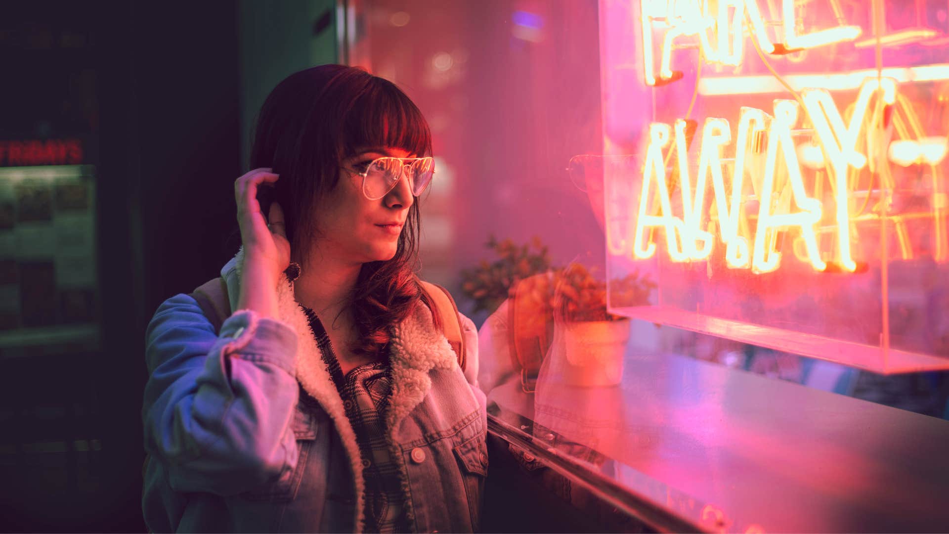 annoyed woman looking at bright neon sign