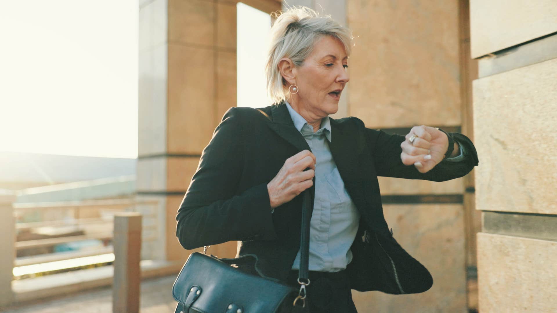 woman looking at watch being in a rush