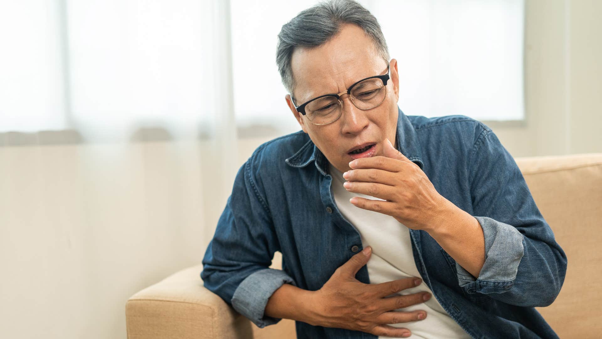 unhygienic man coughing and sneezing openly spreading germs