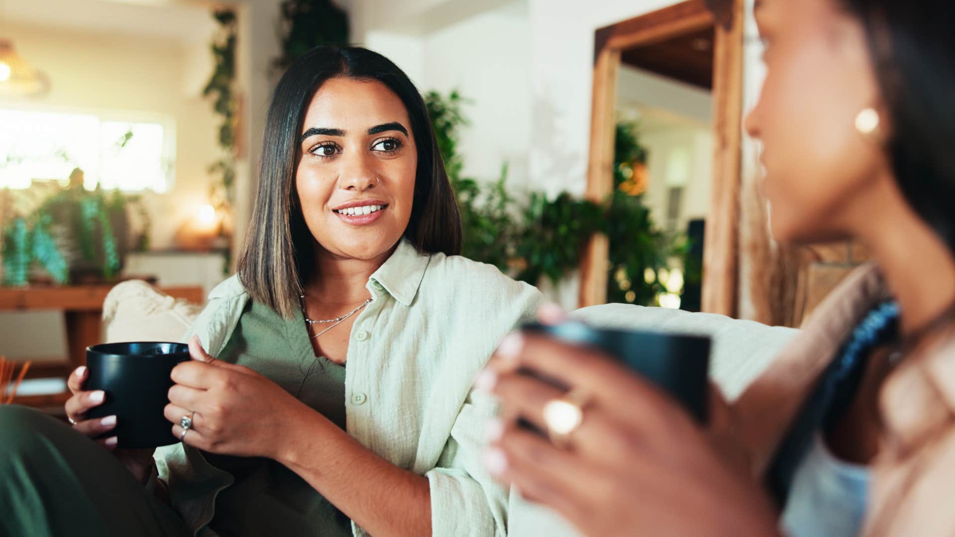 introverted woman who appreciates familiarity socializing with friend at home