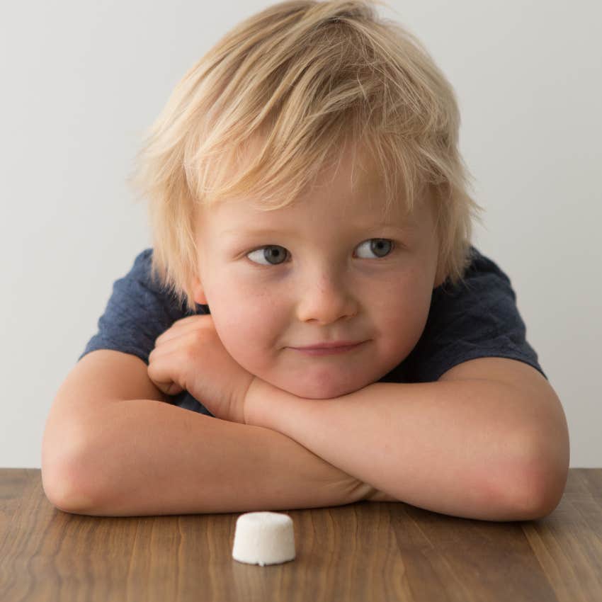 little boy taking the marshmallow test
