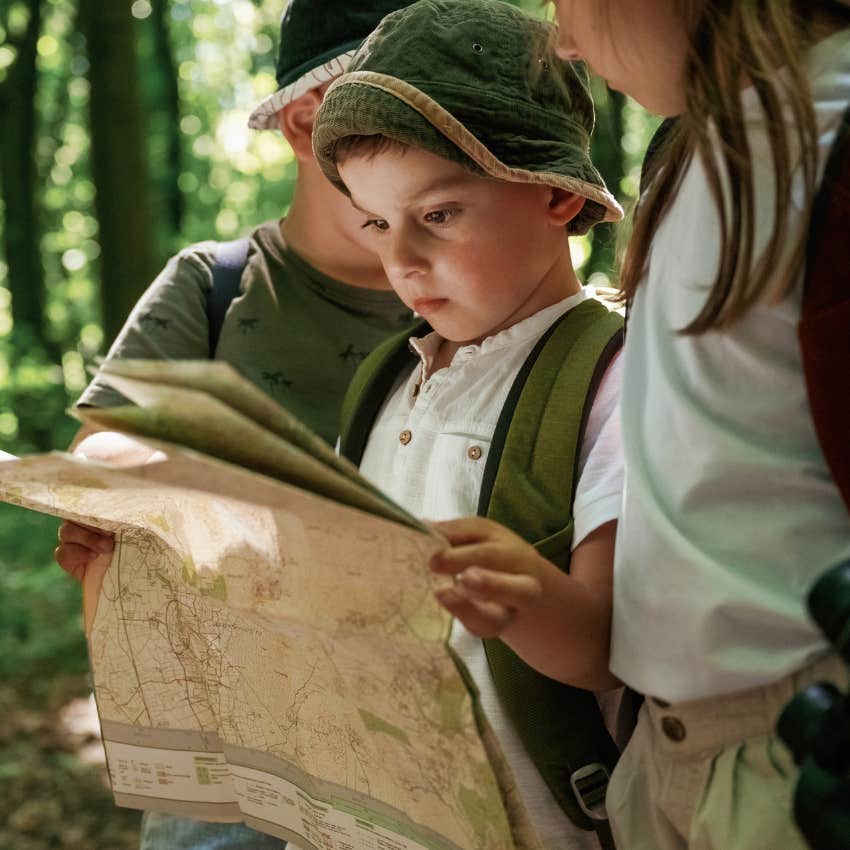 little boy navigating without GPS outside