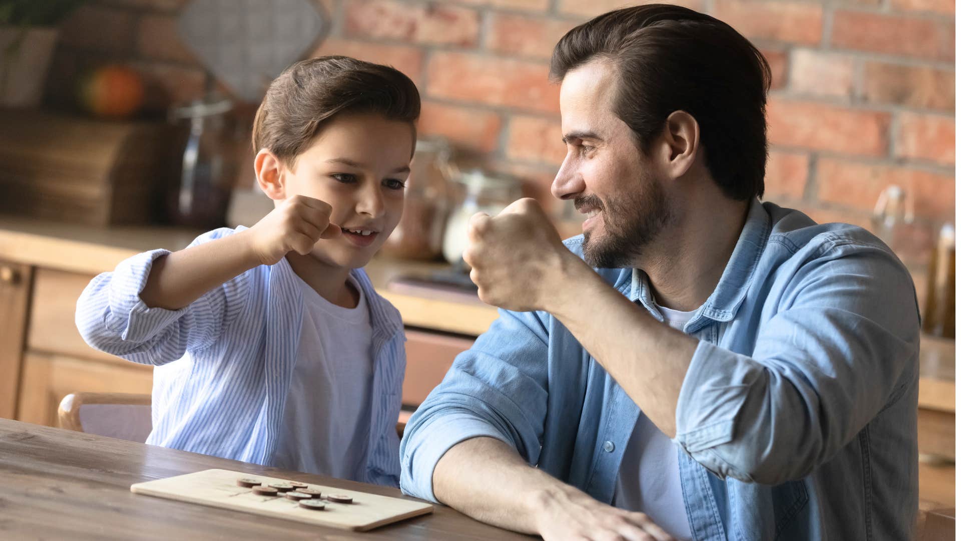 Proud parent acknowledges good kid with a fist bump