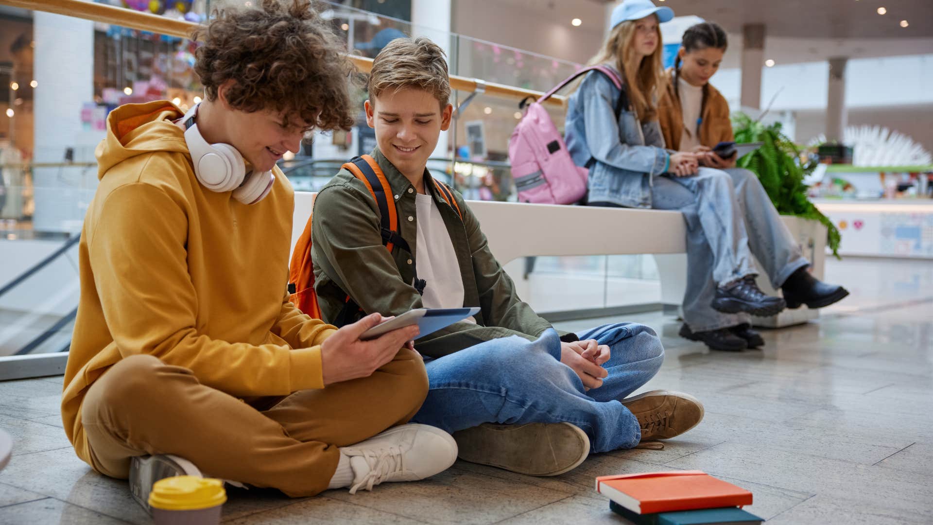 kids hanging out on the floor of the mall