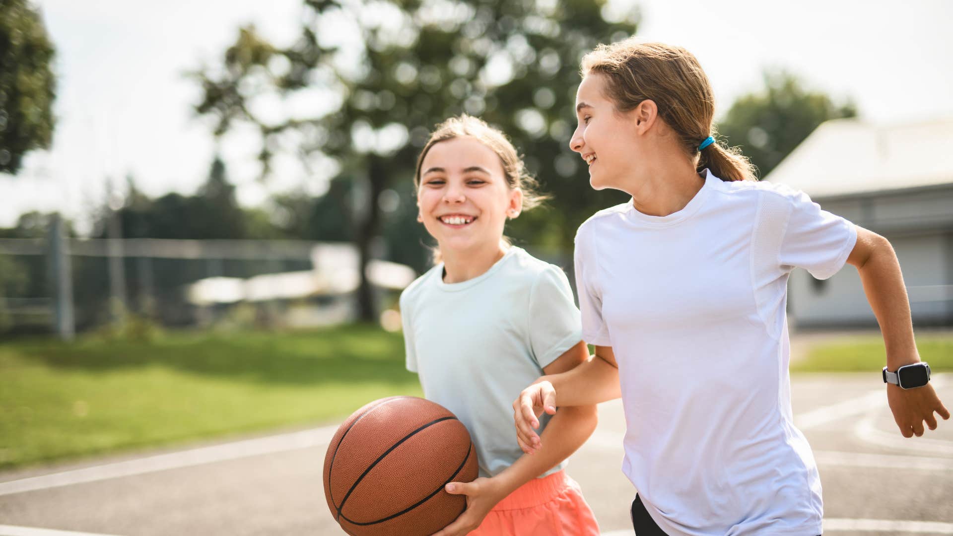 girls playing basketball outside without supervision