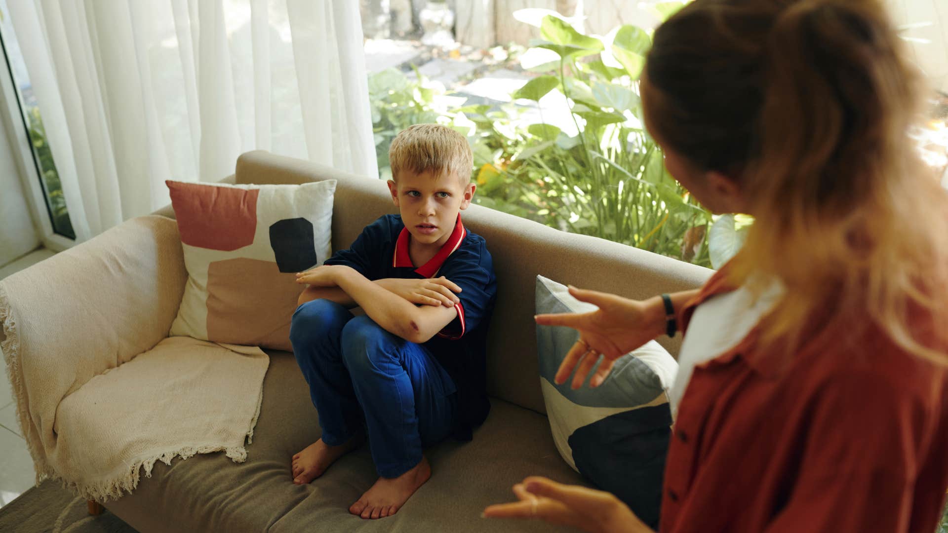 woman chiding a young child friend of her kids