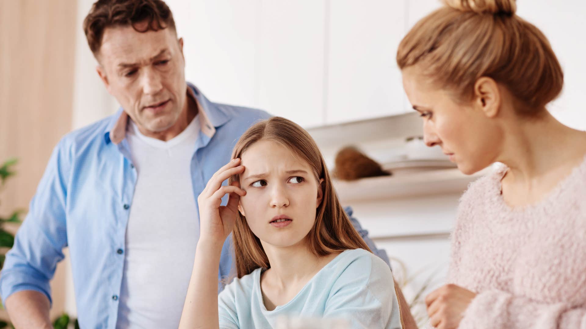 parents talking to daughter about leaving her out of family events