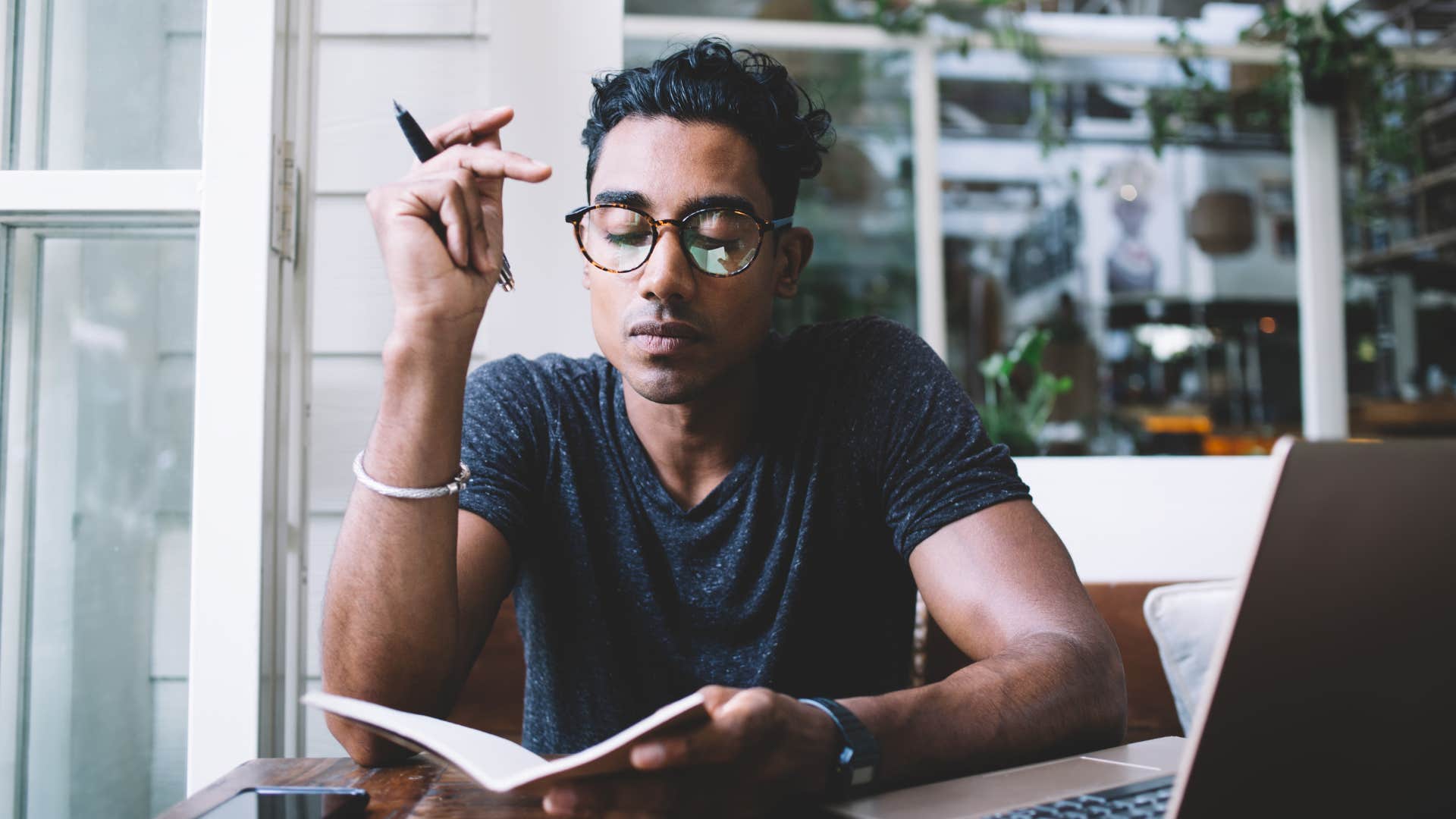 Man with a lone wolf mentality works in a notebook alone 