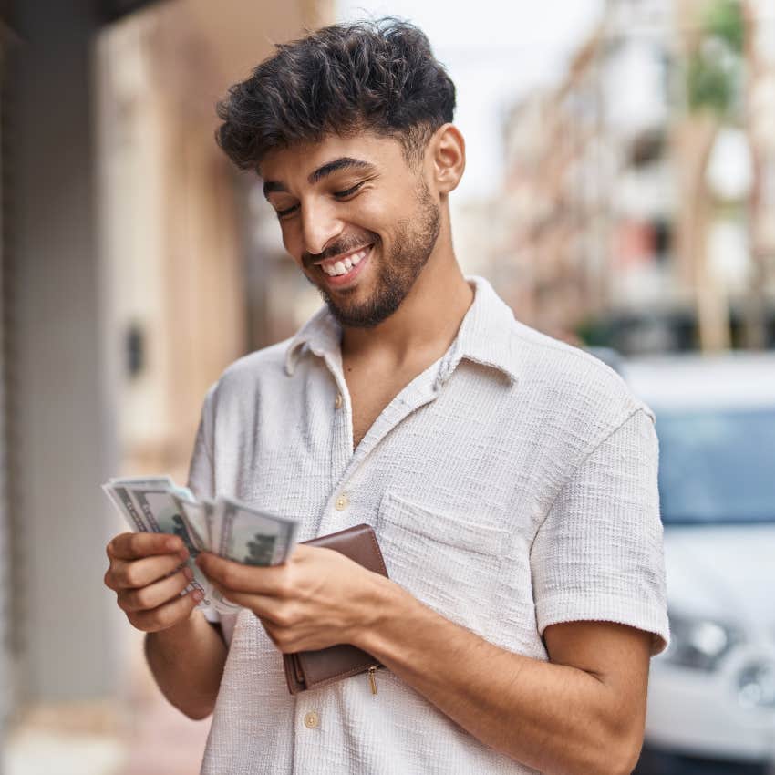 smiling man counting money