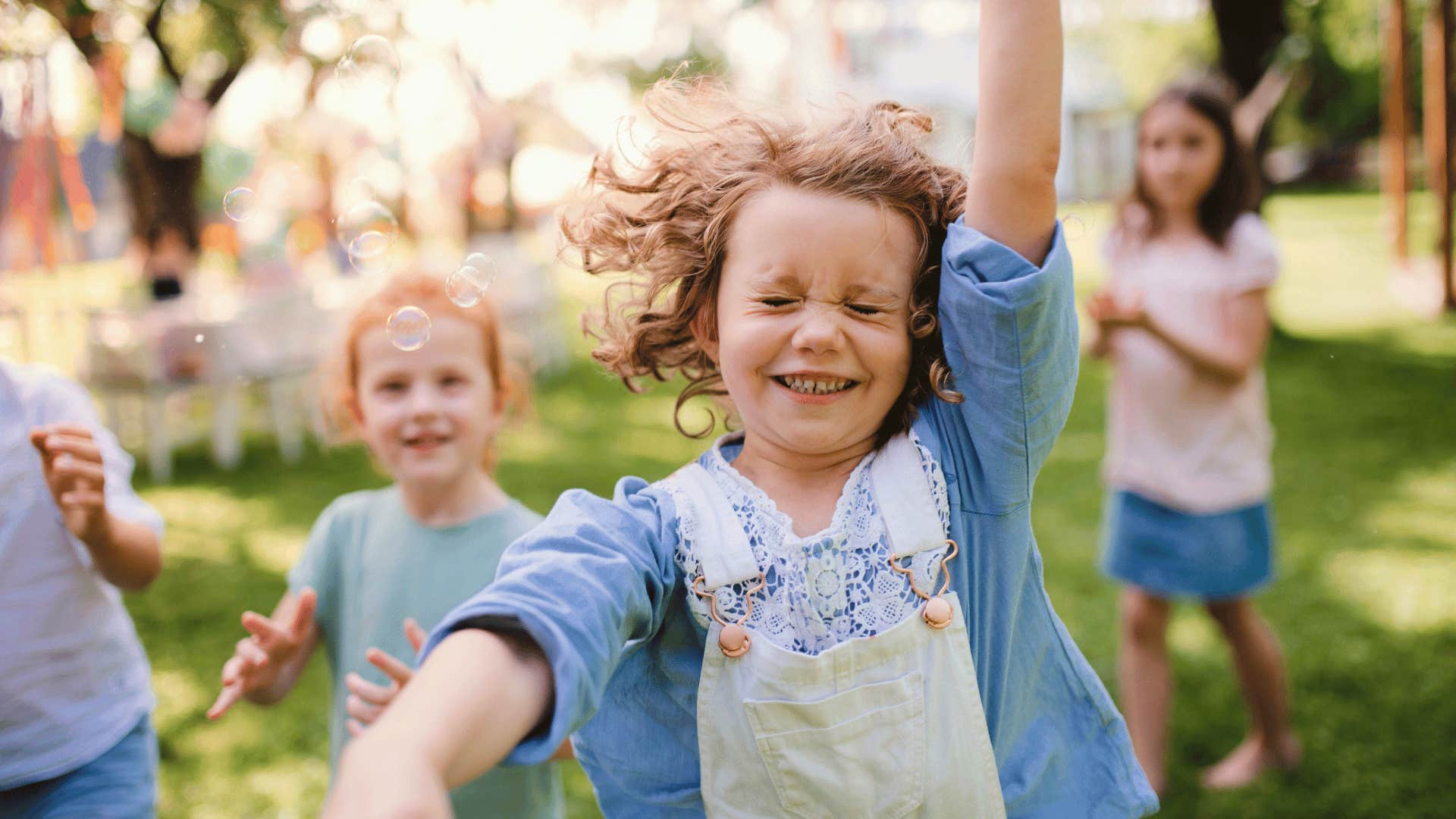 little girl and friends dancing silly together