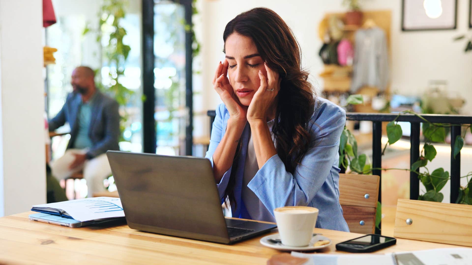 Woman who notices things easily sitting at work annoyed.