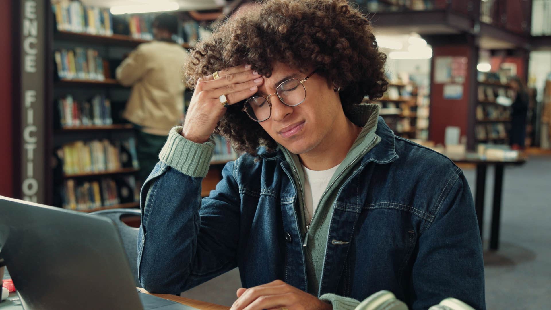 Socially aware and respectful man sitting in a library.