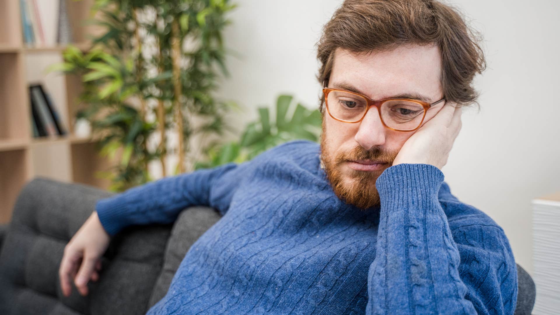 Man who's often a worrier by nature sitting at home.