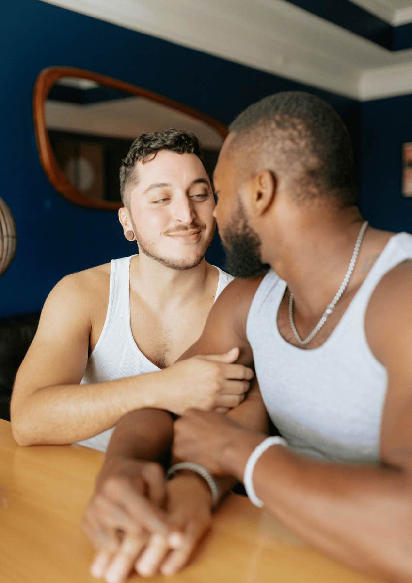 loving male couple sitting close to each other