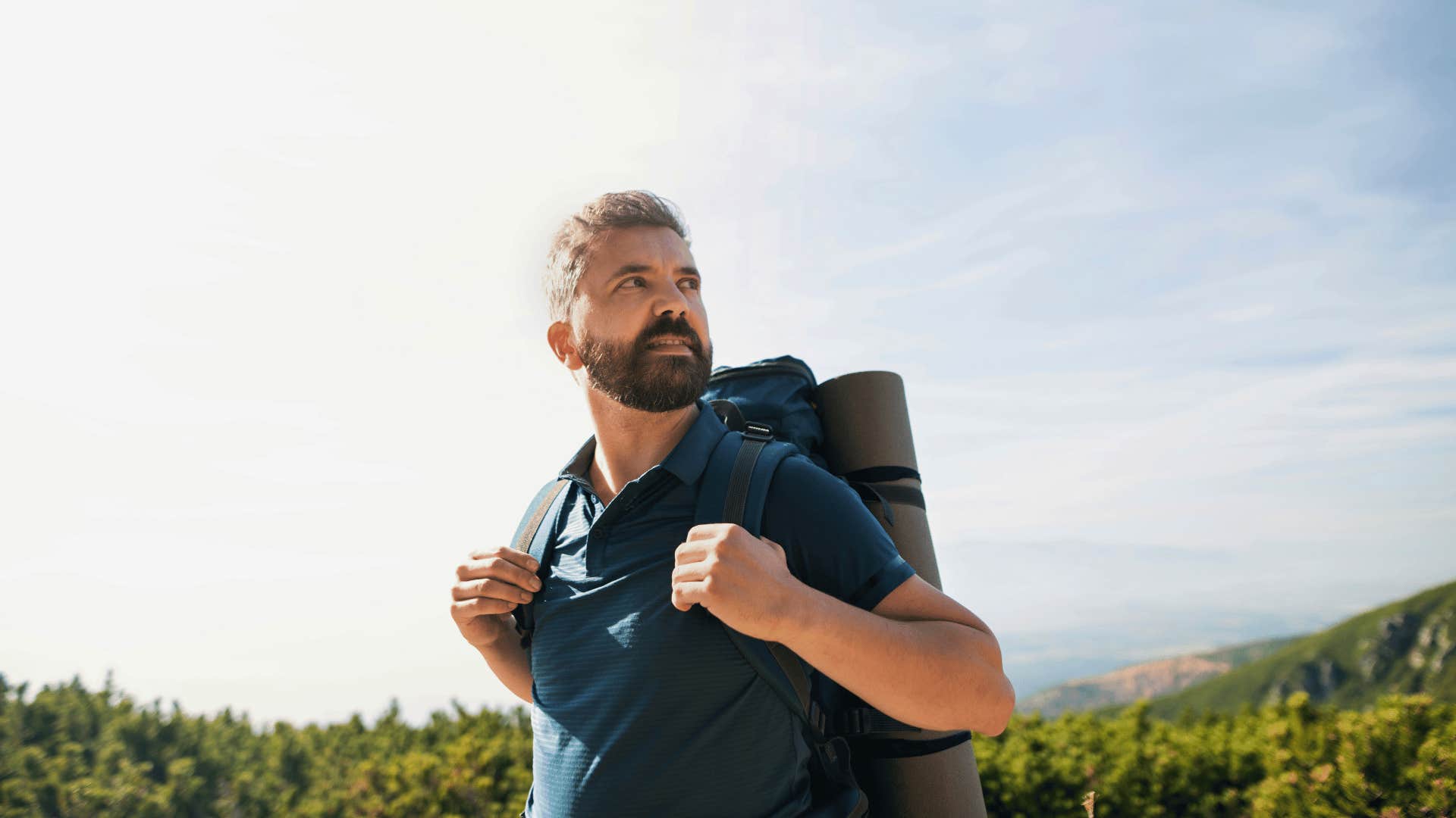 middle age man as a solo traveler backpacking regretting missing out on living