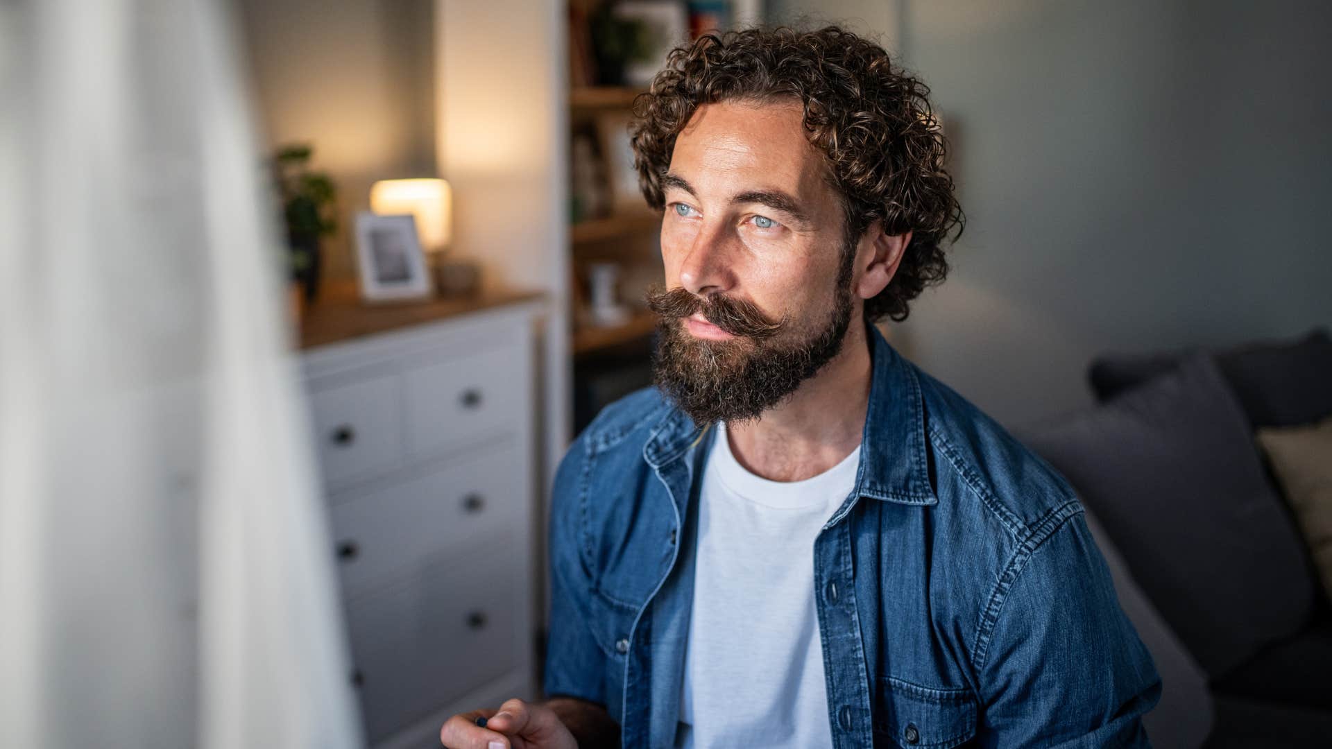 deeply reflective man thinking about his few friends and no social plans