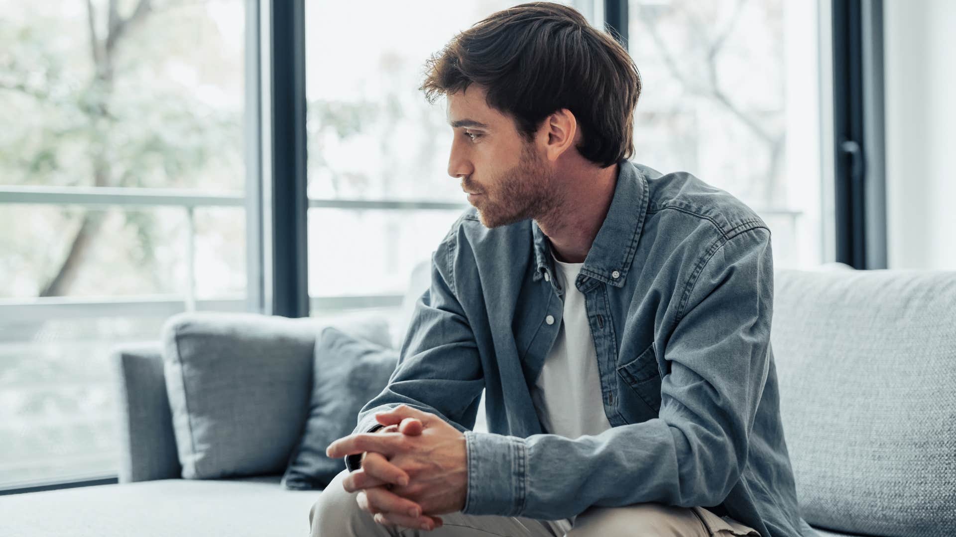 lonely man sitting at home having a hard time trusting people