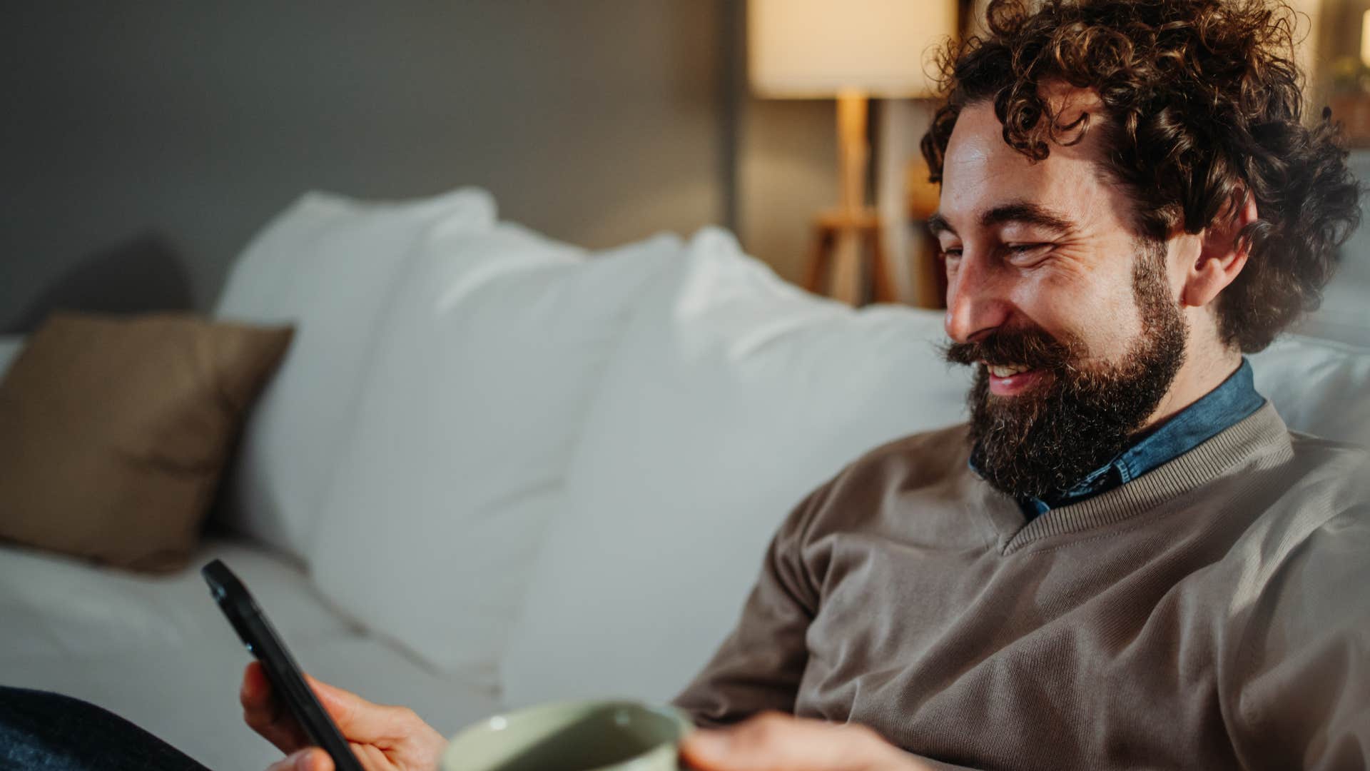 Man texting "I'm thinking about you" on his phone.