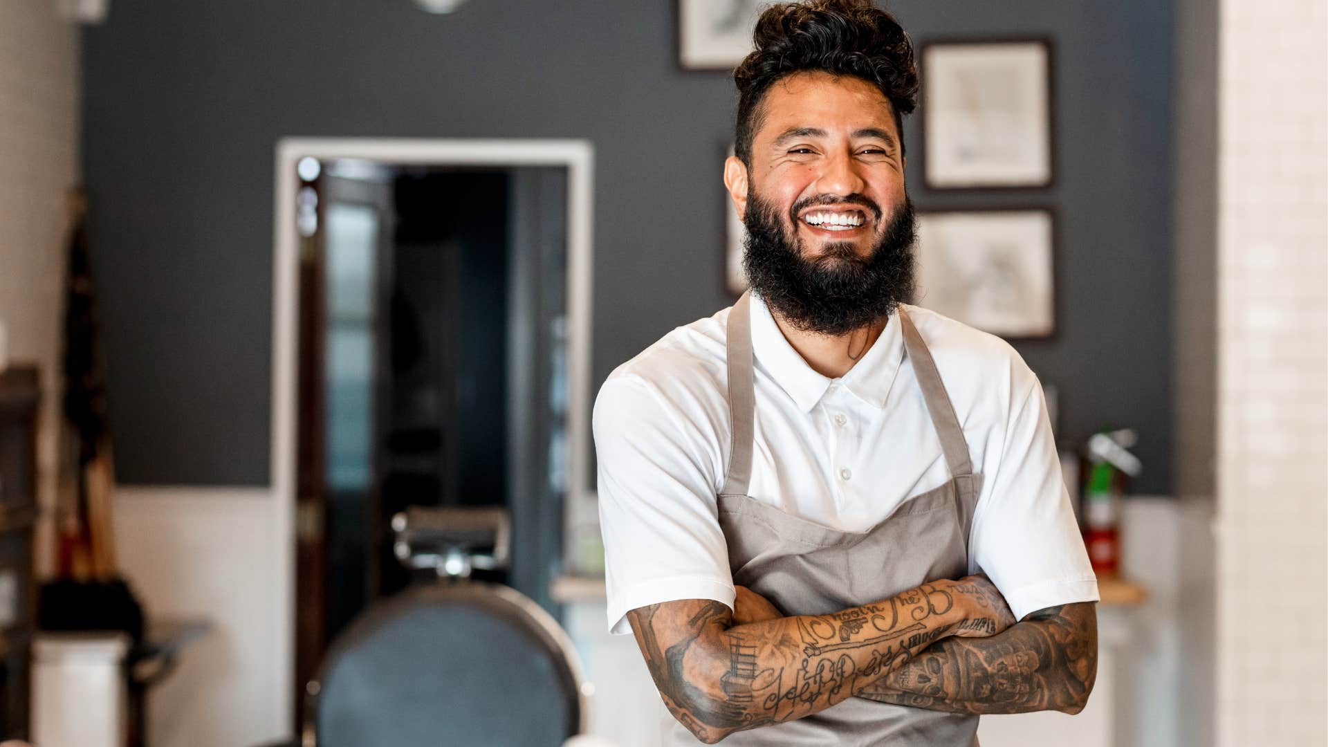 bold man with tattoos smiling at work