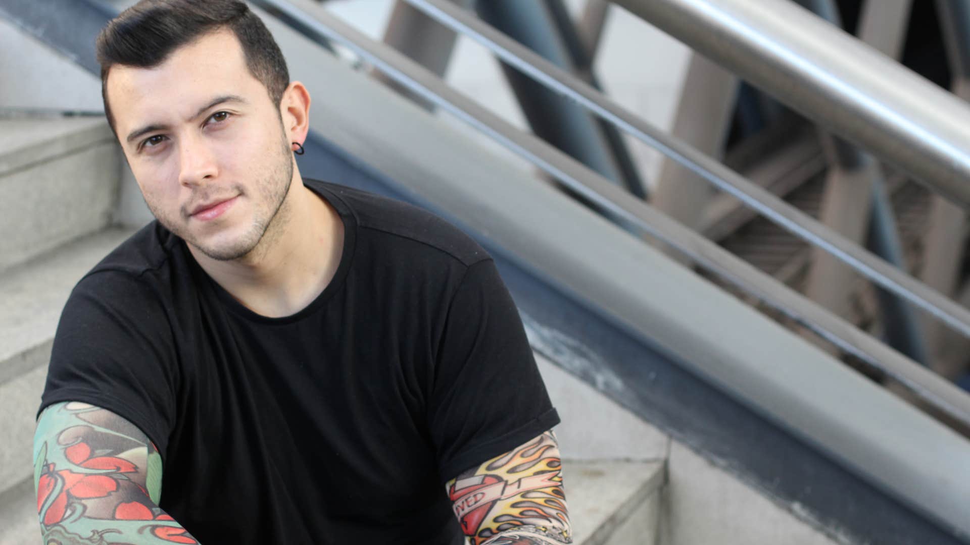 man with tattoos who wants to heal sitting outside alone