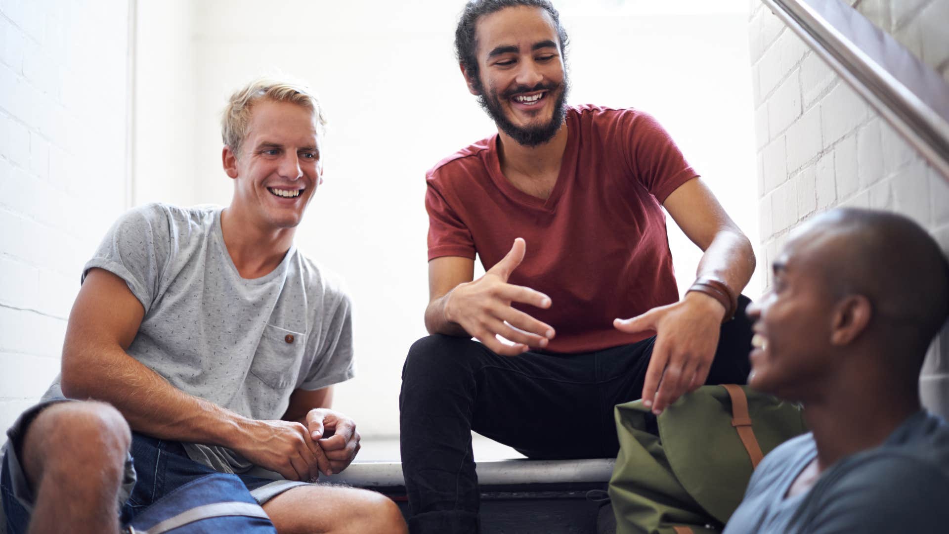 three men sitting on steps talking about the importance of community
