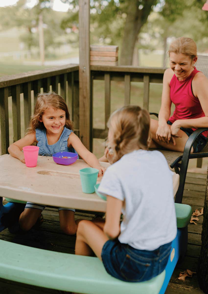 mom watching young girls playing