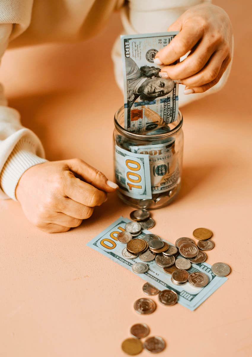 money savings being placed inside a jar