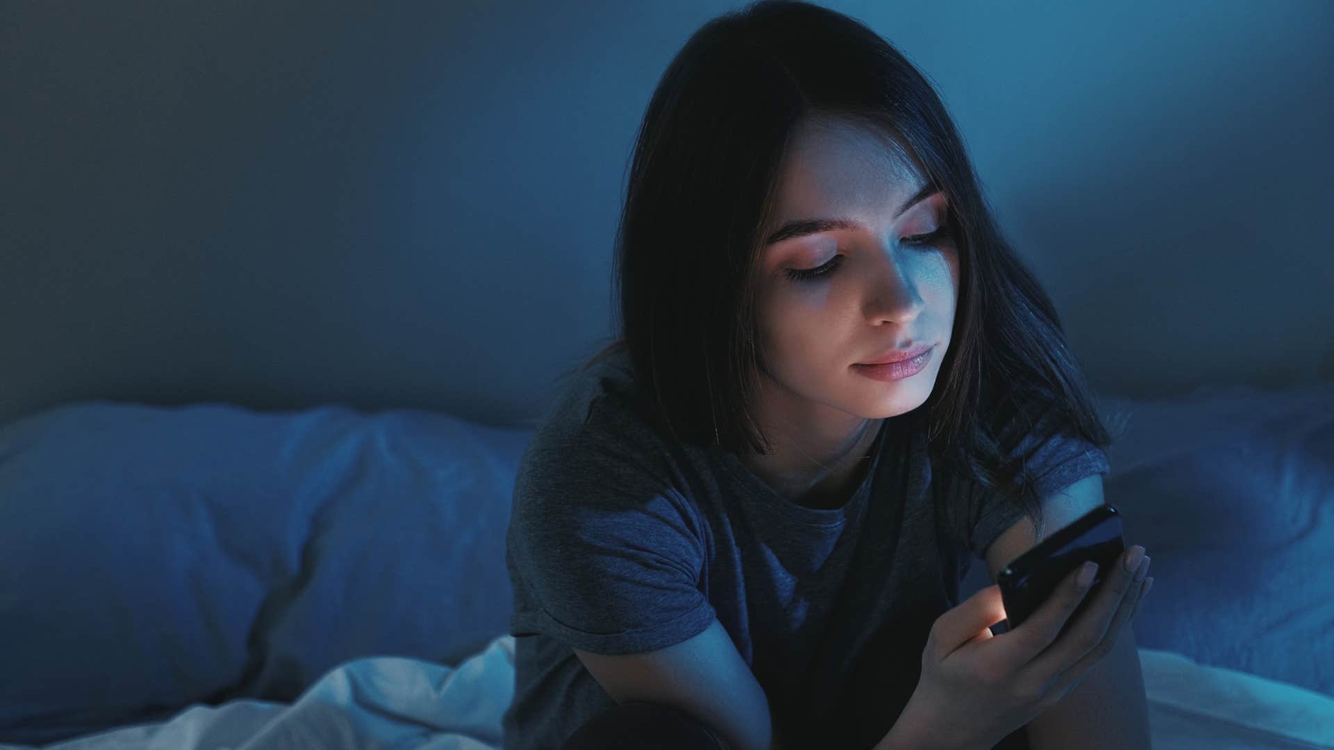 Gen Z woman overusing phones and technology at home