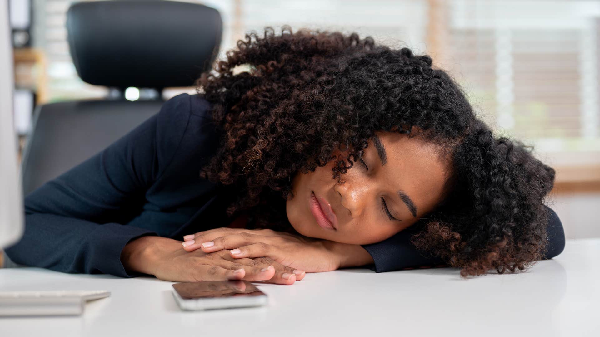 Gen Z woman with a lack of resilience sleeping at work