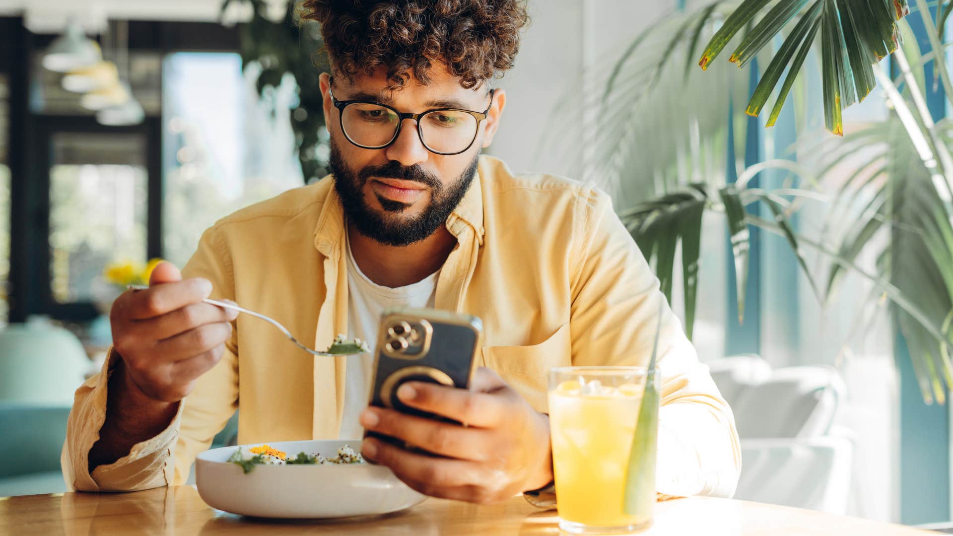 gen z man on his phone with excessive social media presence