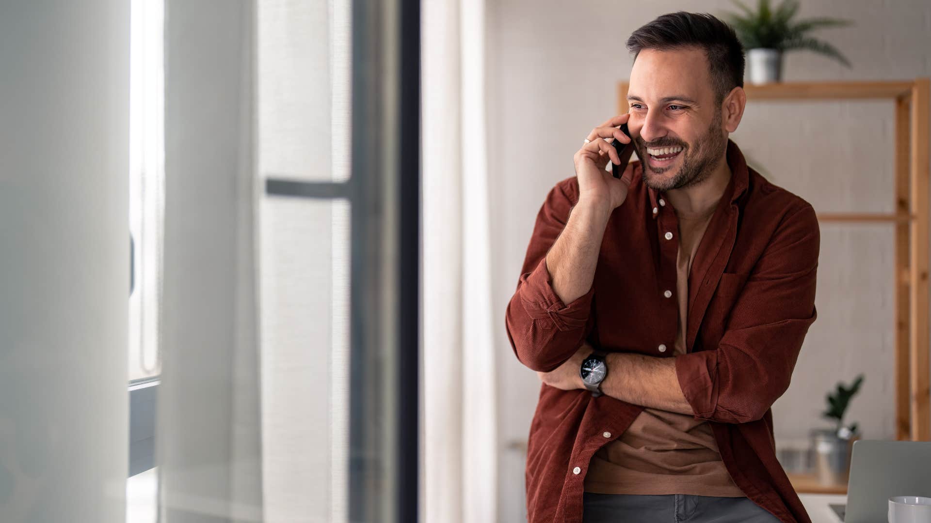 gen z man talking on phone making last minute plans